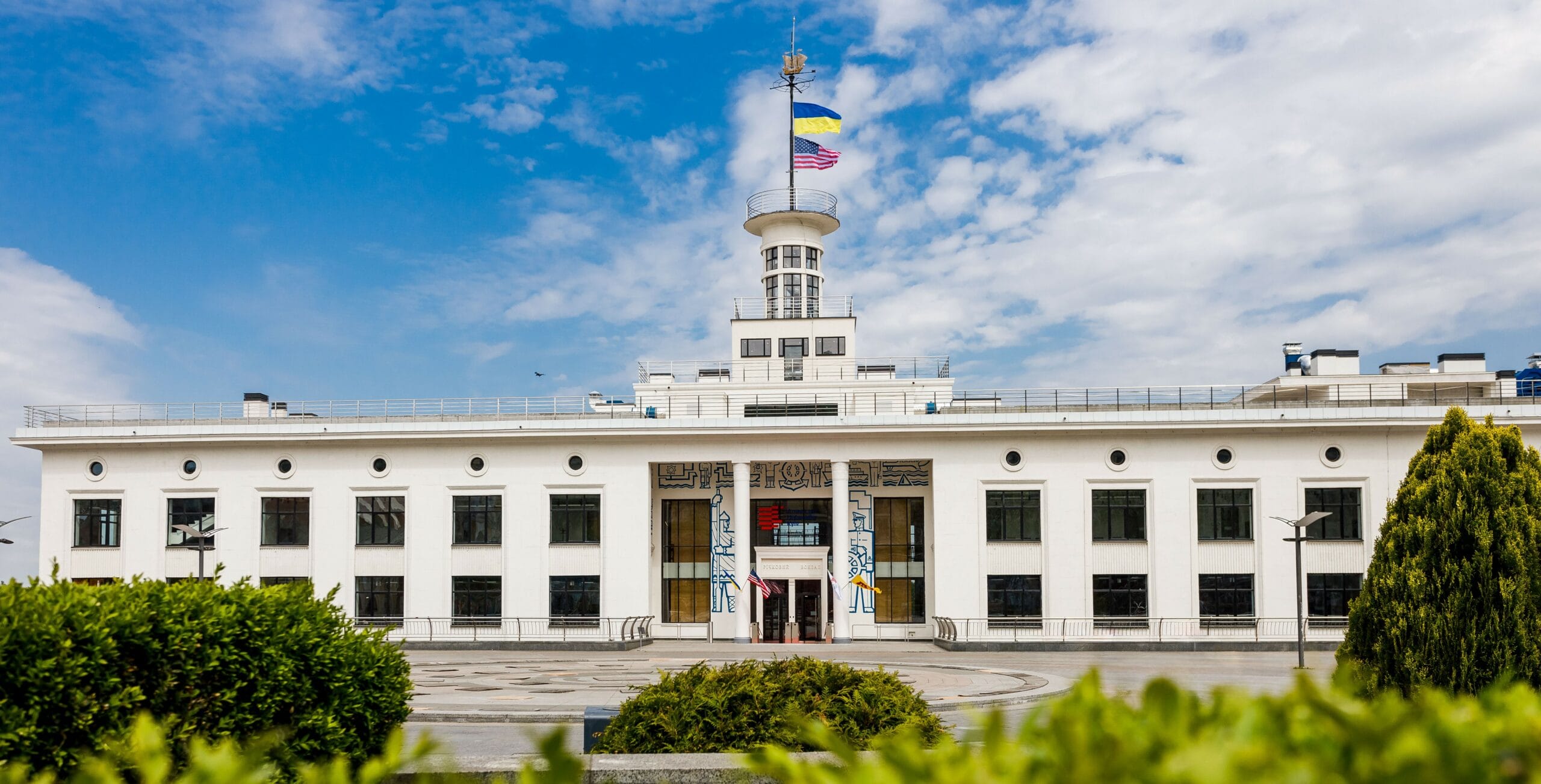 Front view of American University Kyiv with Ukrainian and American flags on a central tower.