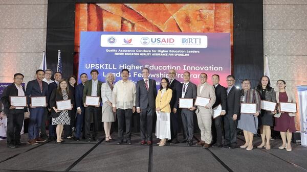 USAID/Philippines Mission Director Ryan Washburn (center, in suit and tie) and CHED Chairman J. Prospero De Vera III (center in white button-down shirt) launch the USAID UPSKILL Higher Education Innovation Leaders Fellowship Program. The launch featured the first batch of fellows, composed of 16 senior academic leaders and higher education officials from across the Philippines who will participate in an eight-month learning program, including sessions at Arizona State University, so they can drive innovatio