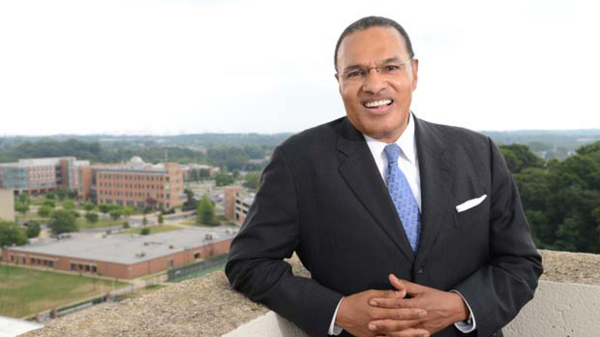 Dr. Freeman A. Hrabowski, III, President Emeritus, UMBC posing for a photo in front of campus.