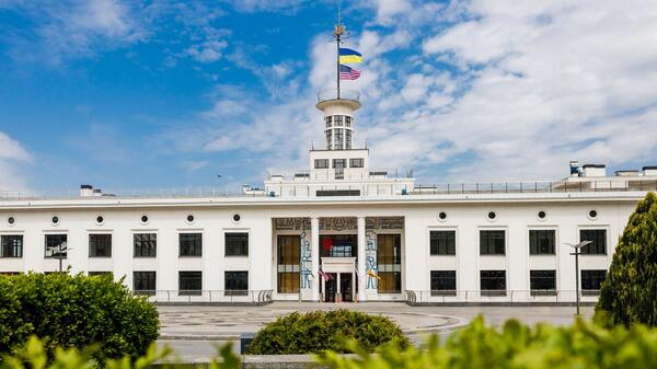 Front view of American University Kyiv with Ukrainian and American flags on a central tower.