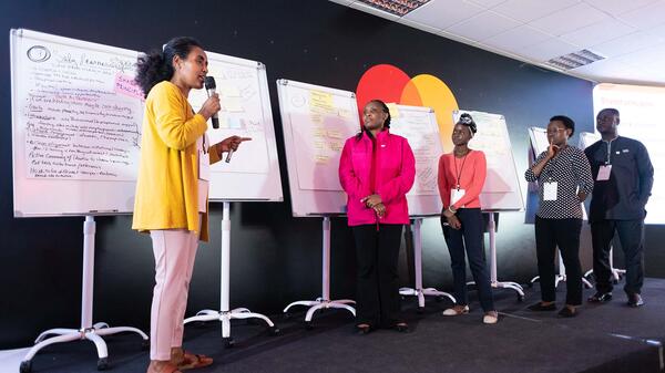 A group of diverse, young leaders on stage