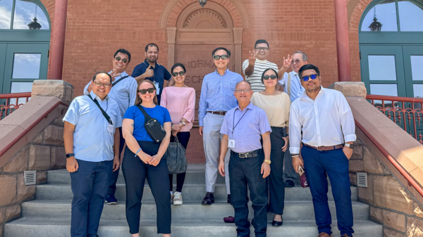 Leaders from the Philippines' Commission on Higher Education gather at Old Main.
